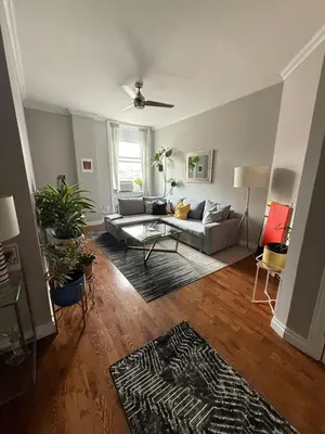 a living room with a couch and a table at Central Park north spacious residence in New York