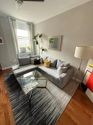 a living room with a couch and a glass table at Central Park north spacious residence in New York