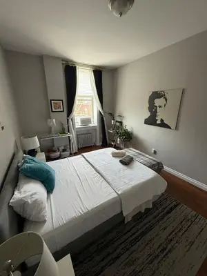 a bedroom with a large bed and a window at Central Park north spacious residence in New York