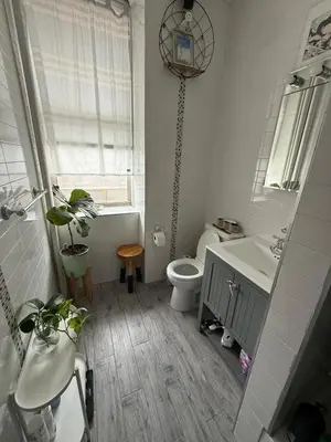 a bathroom with a toilet and a sink and a tub at Central Park north spacious residence in New York