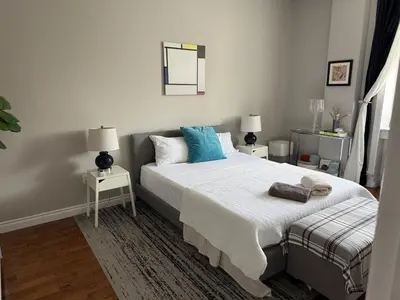 a bedroom with a large bed with blue pillows at Central Park north spacious residence in New York
