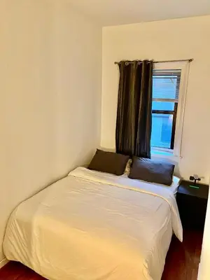 a bed with two pillows on it in a bedroom at Mid Town East Street Apartments Next to Times Square in New York