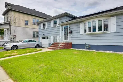 a house with a car parked in front of it at 5 Mi to Dtwn Newark Hillside Vacation Rental in Hillside