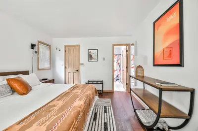 a bedroom with a large bed and a desk at Secluded Retreat w Hot Tub in Windham in Windham