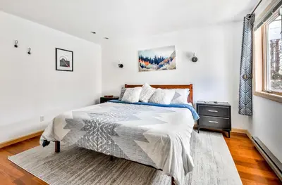 a white bedroom with a bed and a window at Secluded Retreat w Hot Tub in Windham in Windham