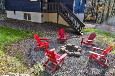 a group of red chairs and a fire pit at Secluded Retreat w Hot Tub in Windham in Windham