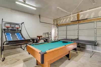 a room with a pool table and a simulator at Family Retreat with 2 Game Rooms and Deck in Long Pond in Long Pond