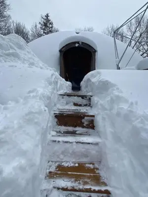 a snow covered staircase leading to a tunnel at Unique Dome Home With Hot Tub & Piano, on 28 acres in New Paltz