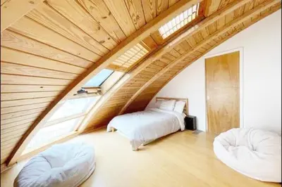 a bedroom with two beds and two ottomans at Unique Dome Home With Hot Tub & Piano, on 28 acres in New Paltz