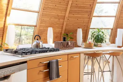 a kitchen with a stove with a tea kettle on it at Unique Dome Home With Hot Tub & Piano, on 28 acres in New Paltz