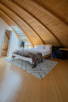 a bedroom with a bed in an attic at Unique Dome Home With Hot Tub & Piano, on 28 acres in New Paltz