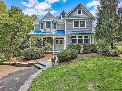 a large house with a driveway in the yard at Charming Country Home with Hot Tub, Pond & Creek in New Paltz