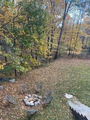a group of chairs sitting on the ground in a park at Charming Country Home with Hot Tub, Pond & Creek in New Paltz