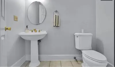 a white bathroom with a toilet and a mirror at Charming Country Home with Hot Tub, Pond & Creek in New Paltz
