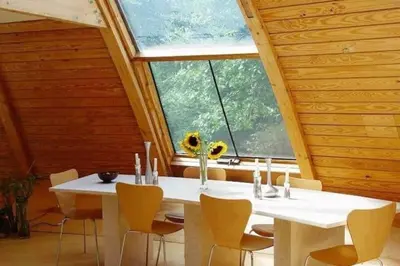 a white table and chairs in a room with a large window at Dome 2Home Villa - Hot Tubs, Sauna & Piano in New Paltz