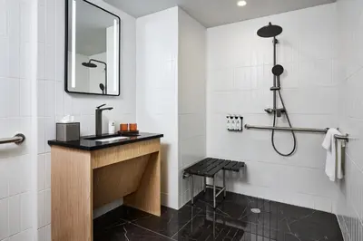 a bathroom with a sink and a shower at The George Manhattan, Tapestry Collection By Hilton in New York