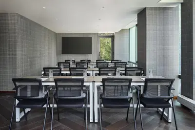 a large conference room with a large table and chairs at The George Manhattan, Tapestry Collection By Hilton in New York