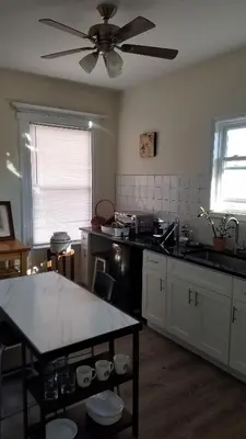 a kitchen with a table and a ceiling fan at Weehawken on Hudson in Union City