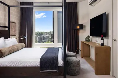 a hotel room with a bed and a window at Luxury Apartments by Hyatus White Plains in White Plains