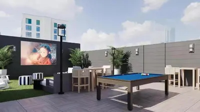 a patio with a ping pong table and a tv at Luxury Apartments by Hyatus White Plains in White Plains