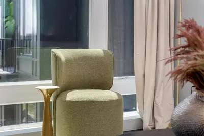 a chair sitting in front of a window at Luxury Apartments by Hyatus White Plains in White Plains