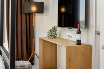 a bottle of wine and a glass on a table at Luxury Apartments by Hyatus White Plains in White Plains