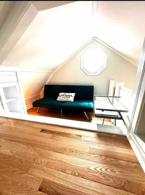 a living room with a green couch and a glass table at coastal and cozy beach stay, pet friendly in Milford
