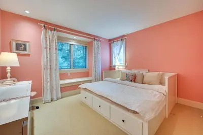 a bedroom with pink walls and a bed with a window at Hot Tub, Gym, Game Room! Luxe Estate in Longmeadow in Longmeadow
