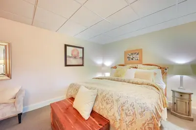 a bedroom with a large bed and a chair at Hot Tub, Gym, Game Room! Luxe Estate in Longmeadow in Longmeadow