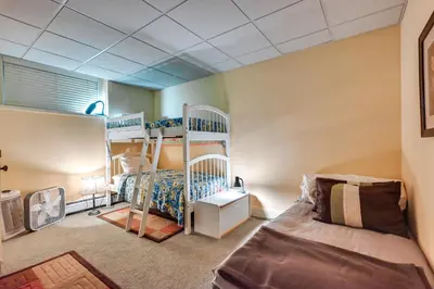 a room with two bunk beds and a bed at Hot Tub, Gym, Game Room! Luxe Estate in Longmeadow in Longmeadow