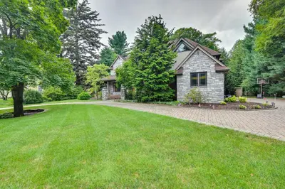 a house with a green lawn in front of it at Hot Tub, Gym, Game Room! Luxe Estate in Longmeadow in Longmeadow