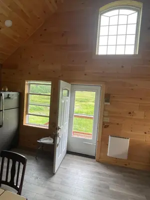 a room with a door and windows in a cabin at Countryside Views in Norwich