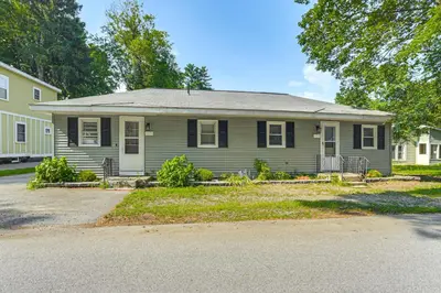 a white house with a gray roof at 1 Mi to Dtwn Saratoga Springs Cozy Duplex Apt! in Saratoga Springs