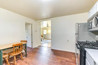 a kitchen with a table and a stove top oven at 1 Mi to Dtwn Saratoga Springs Cozy Duplex Apt! in Saratoga Springs