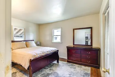 a bedroom with a bed and a mirror and a dresser at 1 Mi to Dtwn Saratoga Springs Cozy Duplex Apt! in Saratoga Springs