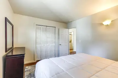 a bedroom with a large white bed and a window at 1 Mi to Dtwn Saratoga Springs Cozy Duplex Apt! in Saratoga Springs