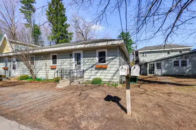 a house with a parking meter in front of it at 1 Mi to Dtwn Saratoga Springs Cozy Duplex Apt! in Saratoga Springs