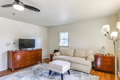 a living room with a couch and a tv at 1 Mi to Dtwn Saratoga Springs Cozy Duplex Apt! in Saratoga Springs