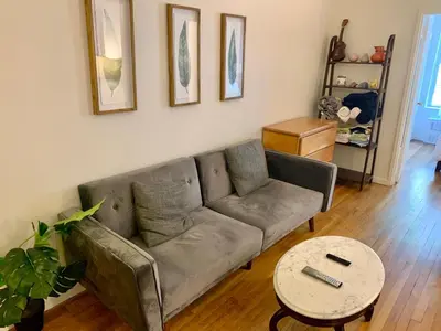 a living room with a couch and a table at PRIME LOCATION 2 BEDROOMS APT UPPER EAST SIDe in New York