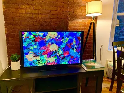 a flat screen tv sitting on top of a table at PRIME LOCATION 2 BEDROOMS APT UPPER EAST SIDe in New York