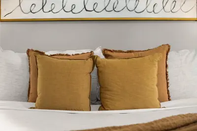 a bed with pillows and a sign on the wall at Chic NYC Retreat Beside Broadway & Iconic Sights in New York