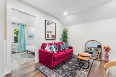 a living room with a red couch and a table at Family Suite - Free Parking - Near NYC & Shops at Main Street in North Bergen
