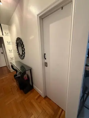a white door in a room with a wooden floor at Bronx City Stay Private Room Near Manhattan in Kings Bridge Heights
