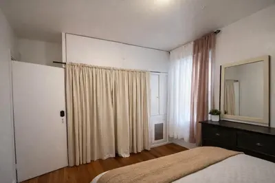 a bedroom with a bed and a mirror and a window at Bronx City Stay Private Room Near Manhattan in Kings Bridge Heights