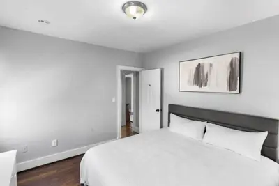 a bedroom with a bed with a white bedspread at Cozy Bedroom next to SCSU in New Haven