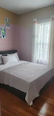 a bedroom with a large bed with a window at Massive 5 bedroom Close to NYC in Newark