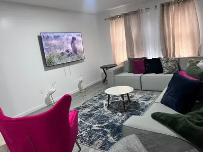 a living room with a couch and a table and chairs at Exquisite Luxury 3KINGs Bed, 2 Bath in Newark