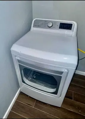 a white microwave oven sitting on top of a floor at Cozy Rooms in a Modern and Beautiful Apartment in Irvington