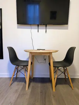 a table with two chairs and a television on a wall at Apartment near Times Square Manhattan New York in New York