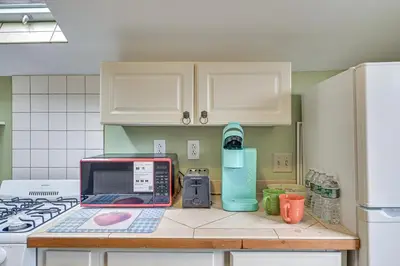 a kitchen with a counter top with a laptop on it at Quaint and Charming Cherry Valley Escape! in Cherry Valley